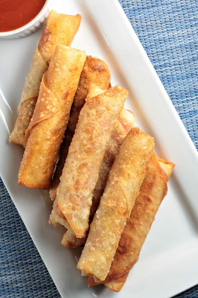 Pepperoni Pizza Egg Rolls feature mozzarella string cheese, sliced pepperoni and Italian seasoning wrapped in an egg roll wrapper and the deep fried to perfection. This is an easy and fun appetizer or snack great for kids and adults alike. Mindy's Cooking Obsession
