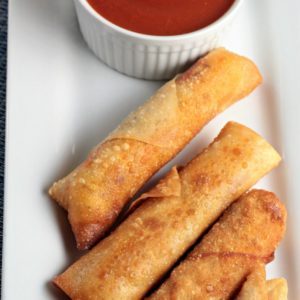 Pepperoni Pizza Egg Rolls feature mozzarella string cheese, sliced pepperoni and Italian seasoning wrapped in an egg roll wrapper and the deep fried to perfection. This is an easy and fun appetizer or snack great for kids and adults alike. Mindy's Cooking Obsession