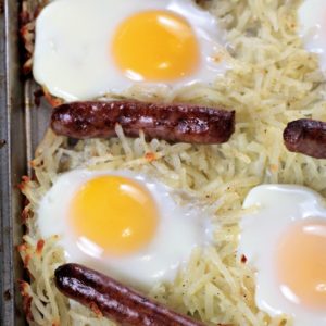 Sausage Sheet Pan Breakfast features store bought hash browns, link sausage, and eggs seasoned with salt and pepper and a splash of melted butter. It is an easy and delicious breakfast, brunch or dinner cooked on one sheet pan. And, clean up is a breeze!