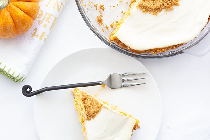 Pumpkin Cream Cheese Pie is an old fashioned recipe featuring canned pumpkin and cream cheese in a graham cracker crust topped with a sweetened sour cream.