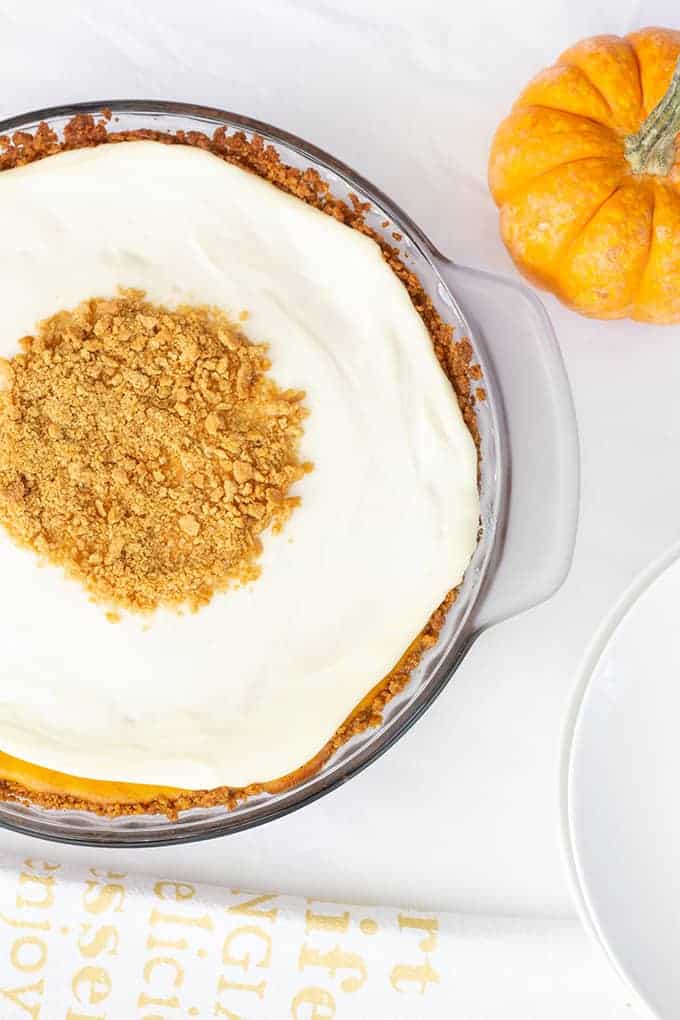 Pumpkin Cream Cheese Pie is an old fashioned recipe featuring canned pumpkin and cream cheese in a graham cracker crust topped with a sweetened sour cream.