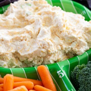 Cheesy Ranch Beer Dip combines cream and cheddar cheese, bottled ranch dressing, beer, green onions and cayenne pepper to make a creamy and spicy dip.