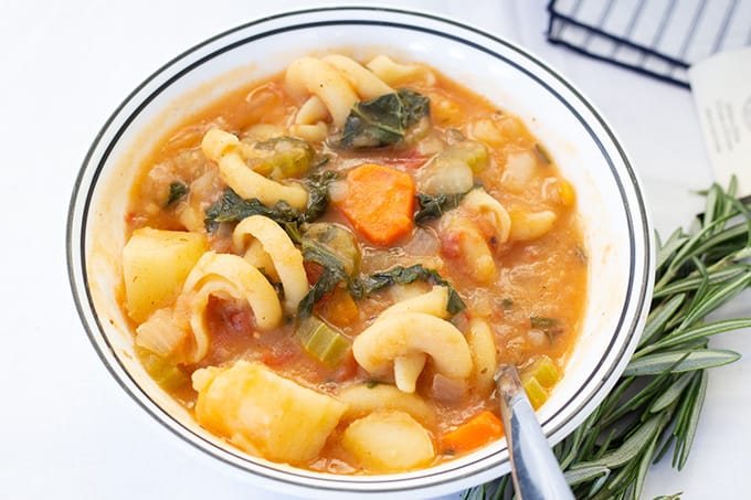 Potato Pasta Kale Soup is a hearty Italian soup that features tomatoes, paprika, fresh thyme and rosemary. Vegan/vegetarian option available.