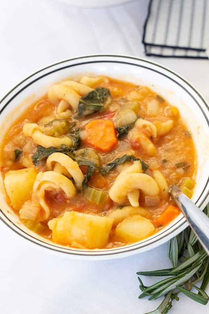 Potato Pasta Kale Soup is a hearty Italian soup that features tomatoes, paprika, fresh thyme and rosemary. Vegan/vegetarian option available.