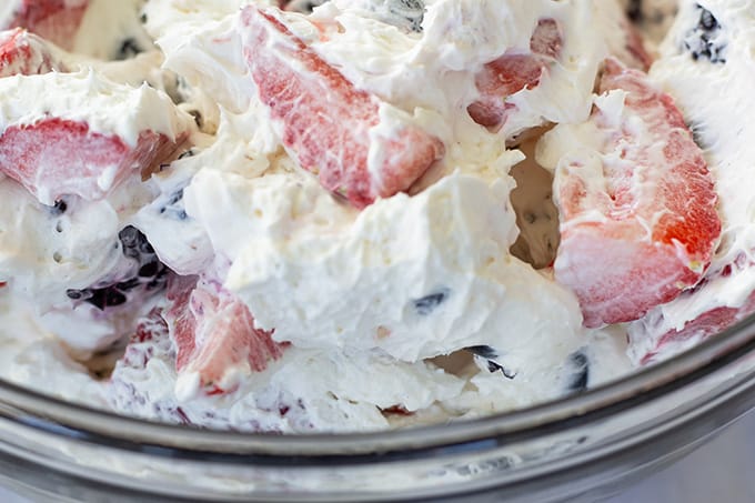 Triple Berry Cheesecake Salad features cream cheese, whipped topping, a little sugar, and plump juicy strawberries, blueberries, and blackberries!