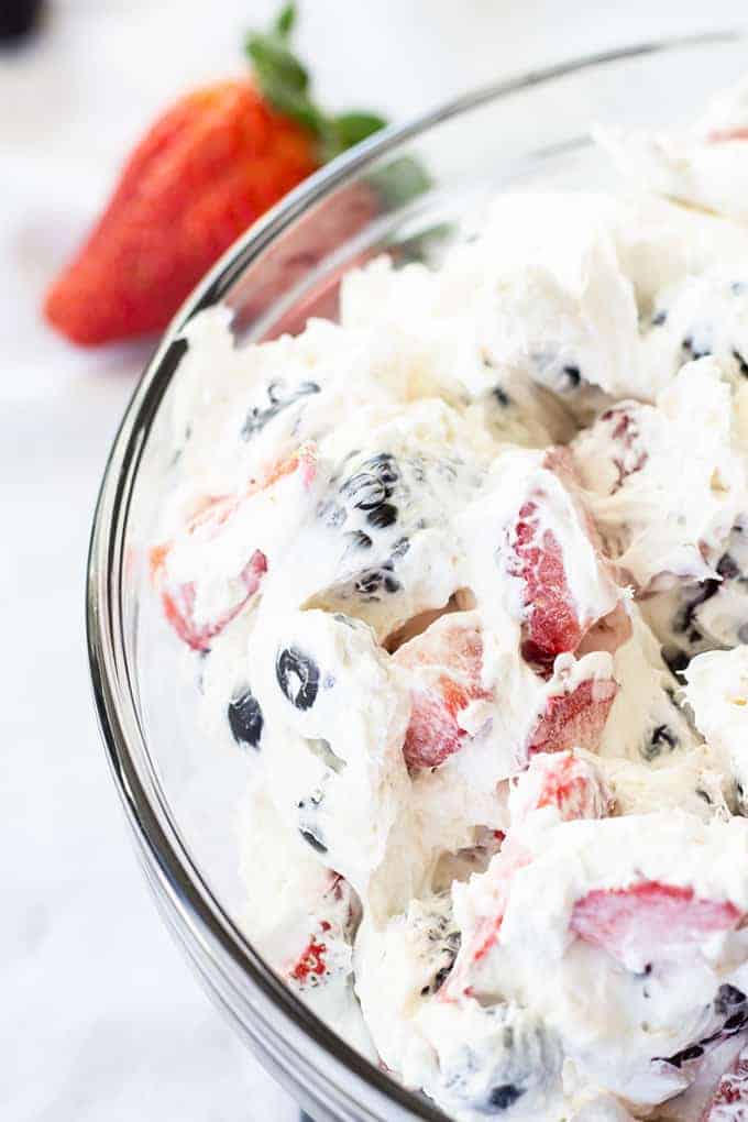 Triple Berry Cheesecake Salad features cream cheese, whipped topping, a little sugar, and plump juicy strawberries, blueberries, and blackberries!