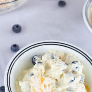 Peach Blueberry Fluff Salad features canned peaches, fresh blueberries, vanilla pudding, cottage cheese and whipped topping. A healthier dessert recipe.