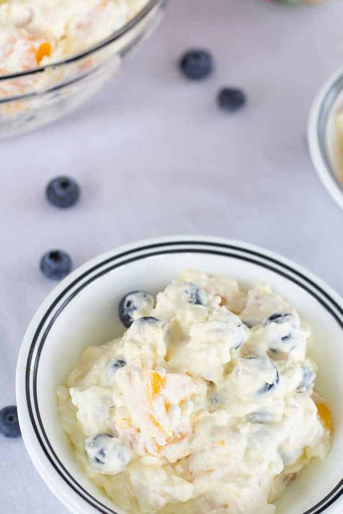 Peach Blueberry Fluff Salad features canned peaches, fresh blueberries, vanilla pudding, cottage cheese and whipped topping. A healthier dessert recipe.