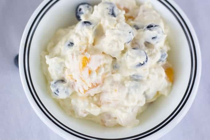 Peach Blueberry Fluff Salad features canned peaches, fresh blueberries, vanilla pudding, cottage cheese and whipped topping. A healthier dessert recipe.