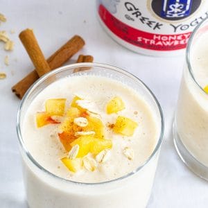 Peach Strawberry Oatmeal Smoothie combines greek yogurt, frozen peaches, milk, oatmeal, honey, cinnamon, vanilla and ice to make a healthy and beverage!