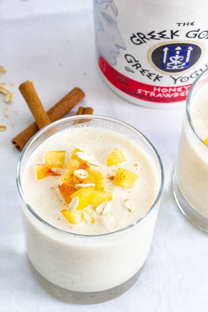 Peach Strawberry Oatmeal Smoothie combines greek yogurt, frozen peaches, milk, oatmeal, honey, cinnamon, vanilla and ice to make a healthy and beverage! 