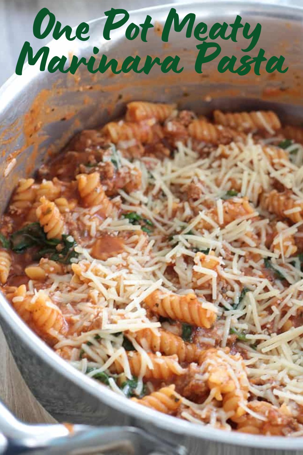 close up view of half a pan of one pot meaty marinara pasta topped with cheese.