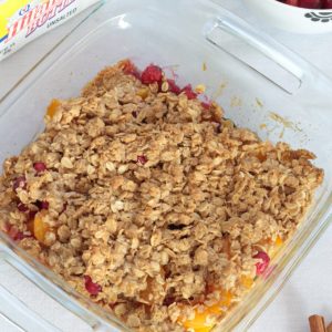 Simple Peach Cranberry Crumble features canned peaches and fresh cranberries, topped with a wholesome spiced cinnamon oat crumble and baked to perfection!