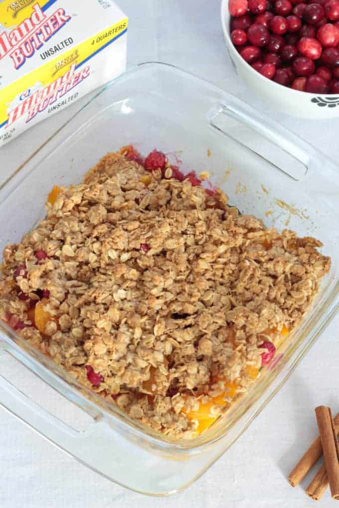 Simple Peach Cranberry Crumble features canned peaches and fresh cranberries, topped with a wholesome spiced cinnamon oat crumble and baked to perfection!