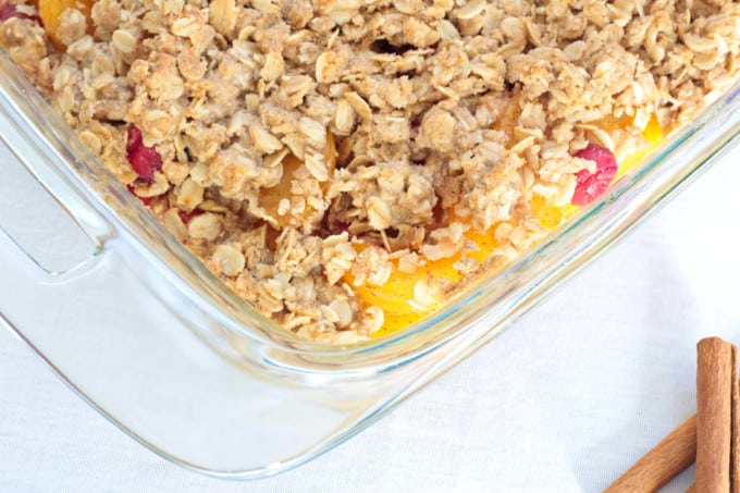 Simple Peach Cranberry Crumble features canned peaches and fresh cranberries, topped with a wholesome spiced cinnamon oat crumble and baked to perfection!