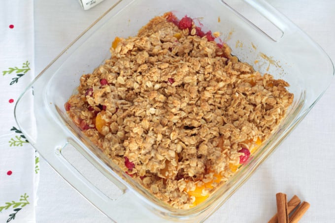 Simple Peach Cranberry Crumble features canned peaches and fresh cranberries, topped with a wholesome spiced cinnamon oat crumble and baked to perfection!