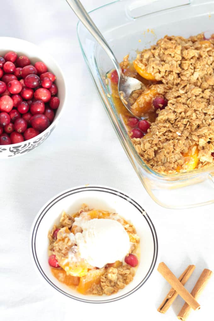 Simple Peach Cranberry Crumble features canned peaches and fresh cranberries, topped with a wholesome spiced cinnamon oat crumble and baked to perfection!