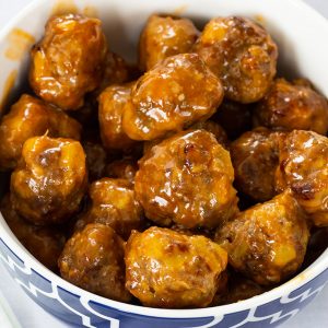 Made with sausage and beef, Sausage Pineapple Mini Meatballs are an easy to make show-stopping tangy and zesty appetizer perfect for a party or game day.