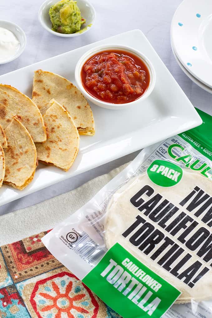 Skinny Bean & Cheese Quesadillas feature refried beans and cheese. They are made with a low fat CAULIPOWER cauliflower tortilla, making them good for you! 