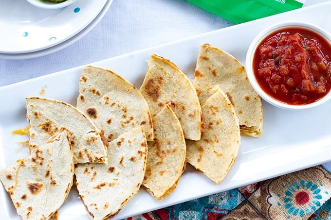 Skinny Bean & Cheese Quesadillas feature refried beans and cheese. They are made with a low fat CAULIPOWER cauliflower tortilla, making them good for you! 