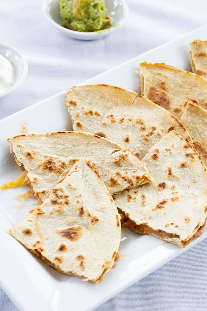 Skinny Bean & Cheese Quesadillas feature refried beans and cheese. They are made with a low fat CAULIPOWER cauliflower tortilla, making them good for you! 