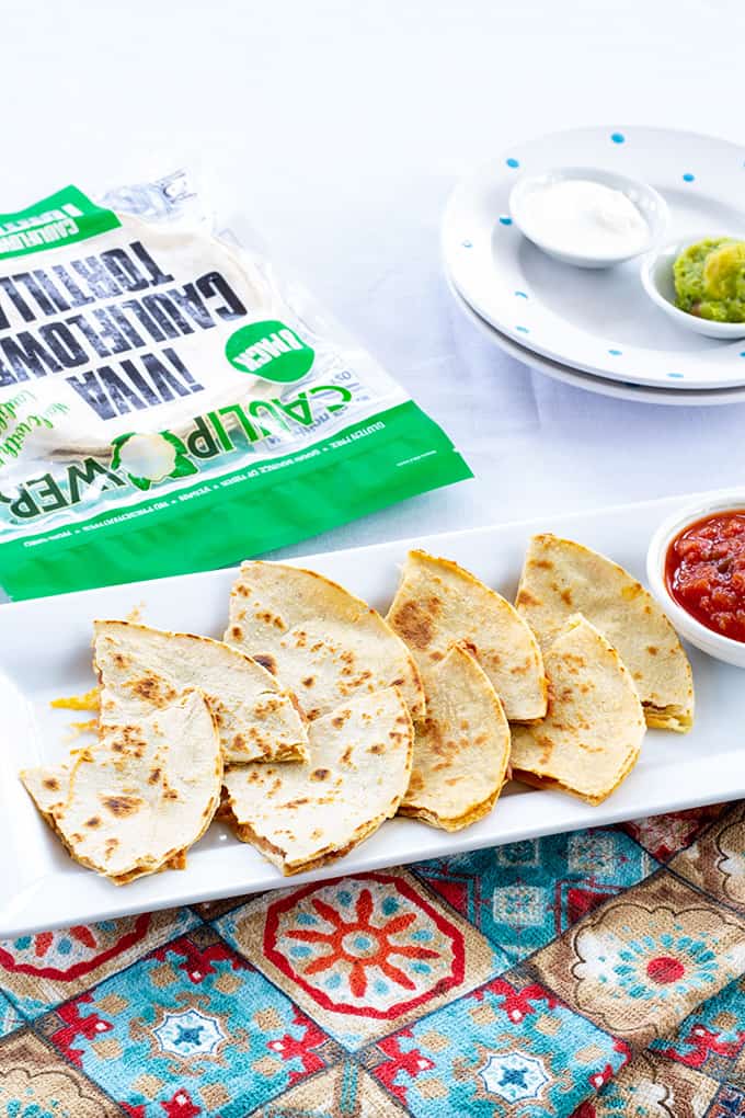 Skinny Bean & Cheese Quesadillas feature refried beans and cheese. They are made with a low fat CAULIPOWER cauliflower tortilla, making them good for you! 