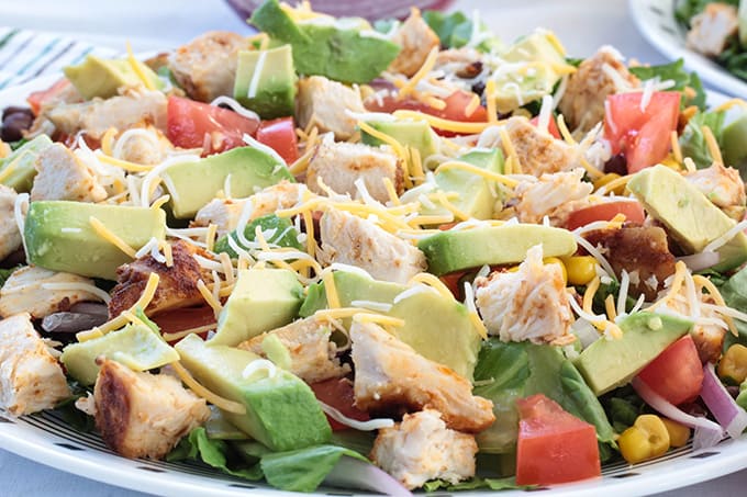 Southwest Ranch Salad with Chicken - green leaf lettuce, red onion, black beans, corn, cheese, tomato and avocado with a greek yogurt Ranch lime dressing.