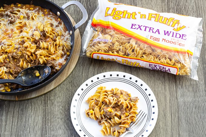 Cheesy Beef Taco Noodles - ground beef, onion, cheese soup, salsa, corn and Light 'n Fluffy Noodles. Easy to make and on the table in about 25 minutes!