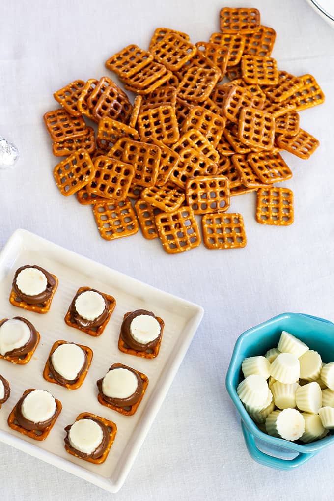 Chocolate Peanut Butter Pretzels feature Hershey's Kisses, Mini White Chocolate Peanut Butter Cups and miniature pretzels. They make a great party snack!