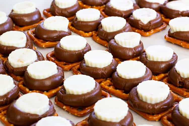 Chocolate Peanut Butter Pretzels feature Hershey's Kisses, Mini White Chocolate Peanut Butter Cups and miniature pretzels. They make a great party snack!