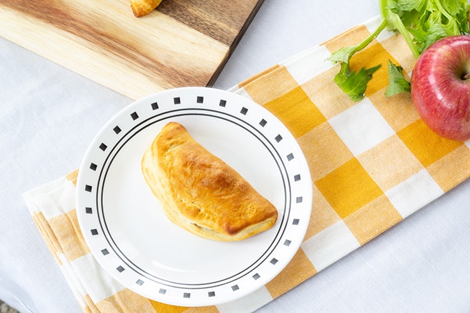 Sausage & Apple Hand Pies are made with ground sausage, apples, celery, and canned biscuits for a tasty mini hand held snack that is so easy to make! 
