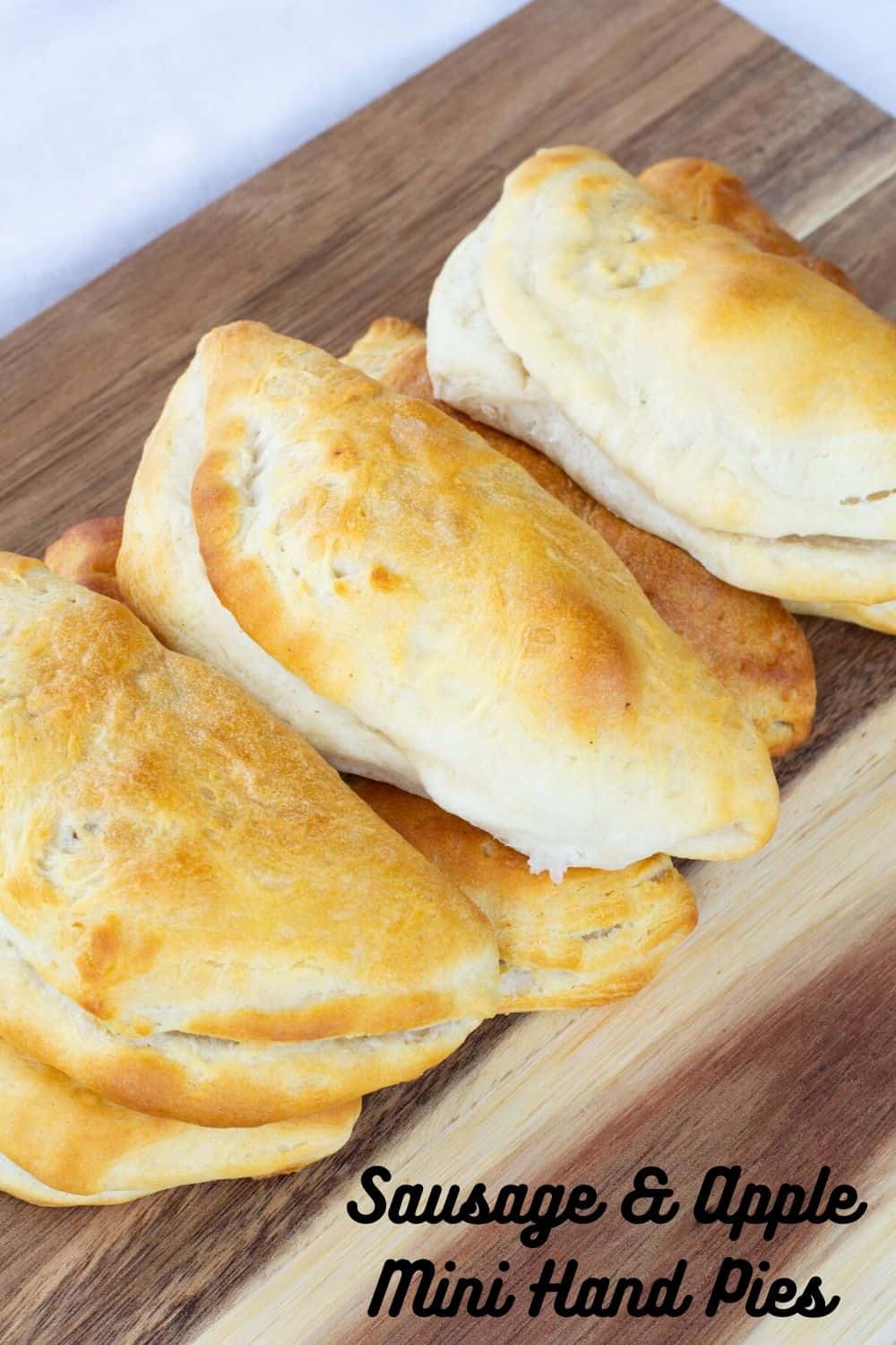 Sausage & Apple Hand Pies are made with ground sausage, apples, celery, and canned biscuits for a tasty mini hand held snack that is so easy to make!