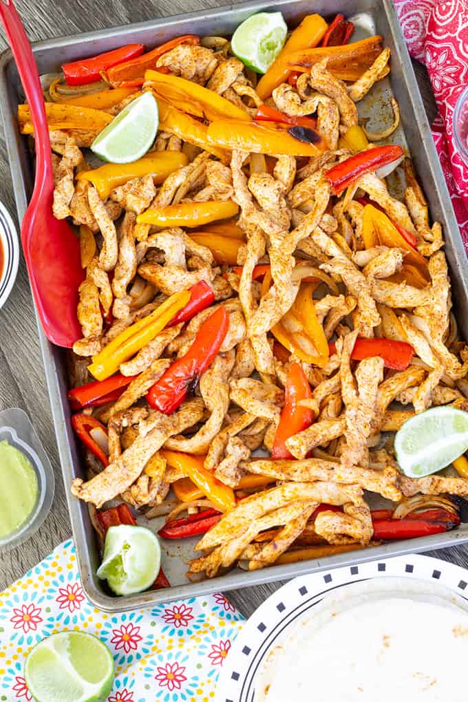 Sheet Pan Chicken Fajitas made with baby bell peppers, onion and chili powder cooked perfectly on a sheet pan, making an easy and quick Tex - Mex meal.