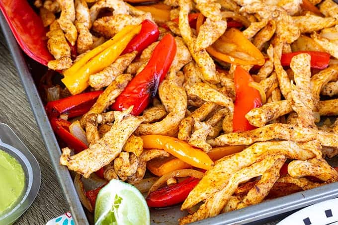 Sheet Pan Chicken Fajitas made with baby bell peppers, onion and chili powder cooked perfectly on a sheet pan, making an easy and quick Tex - Mex meal.