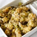 A square white bowl with filled with stove top stuffing