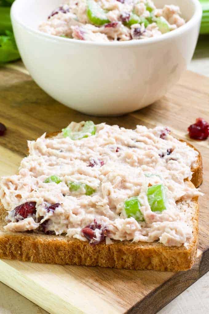 Healthy Cranberry Tuna Salad features canned tuna, mayo, Greek yogurt, celery, craisins, salt, pepper and a splash of lemon juice. So easy!