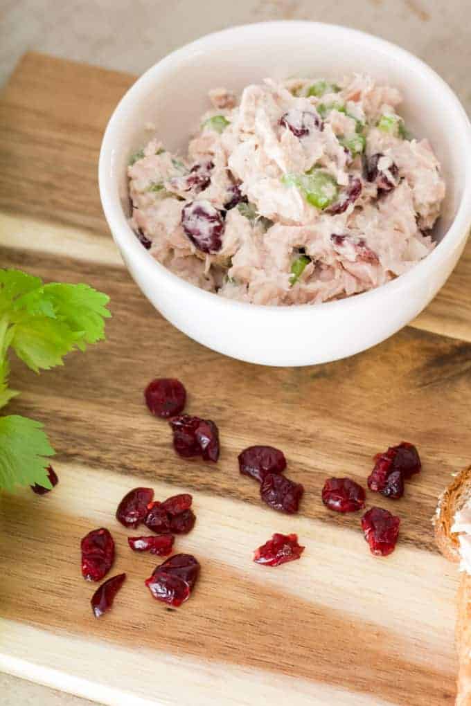 Healthy Cranberry Tuna Salad features canned tuna, mayo, Greek yogurt, celery, craisins, salt, pepper and a splash of lemon juice. So easy!