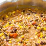 Mild Mexican Taco Chili features ground beef, tomatoes, two kinds of beans, corn, green chiles, taco seasoning and Ranch dressing. 