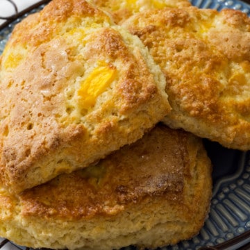 Peach Yogurt Scones are an easy to make delicious biscuit like treat made with butter, flour, sugar, Greek yogurt and frozen peaches.