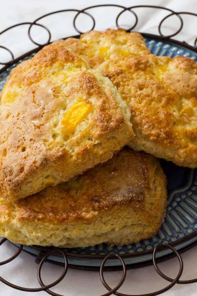 Peach Yogurt Scones are an easy to make delicious biscuit like treat made with butter, flour, sugar, Greek yogurt and frozen peaches.