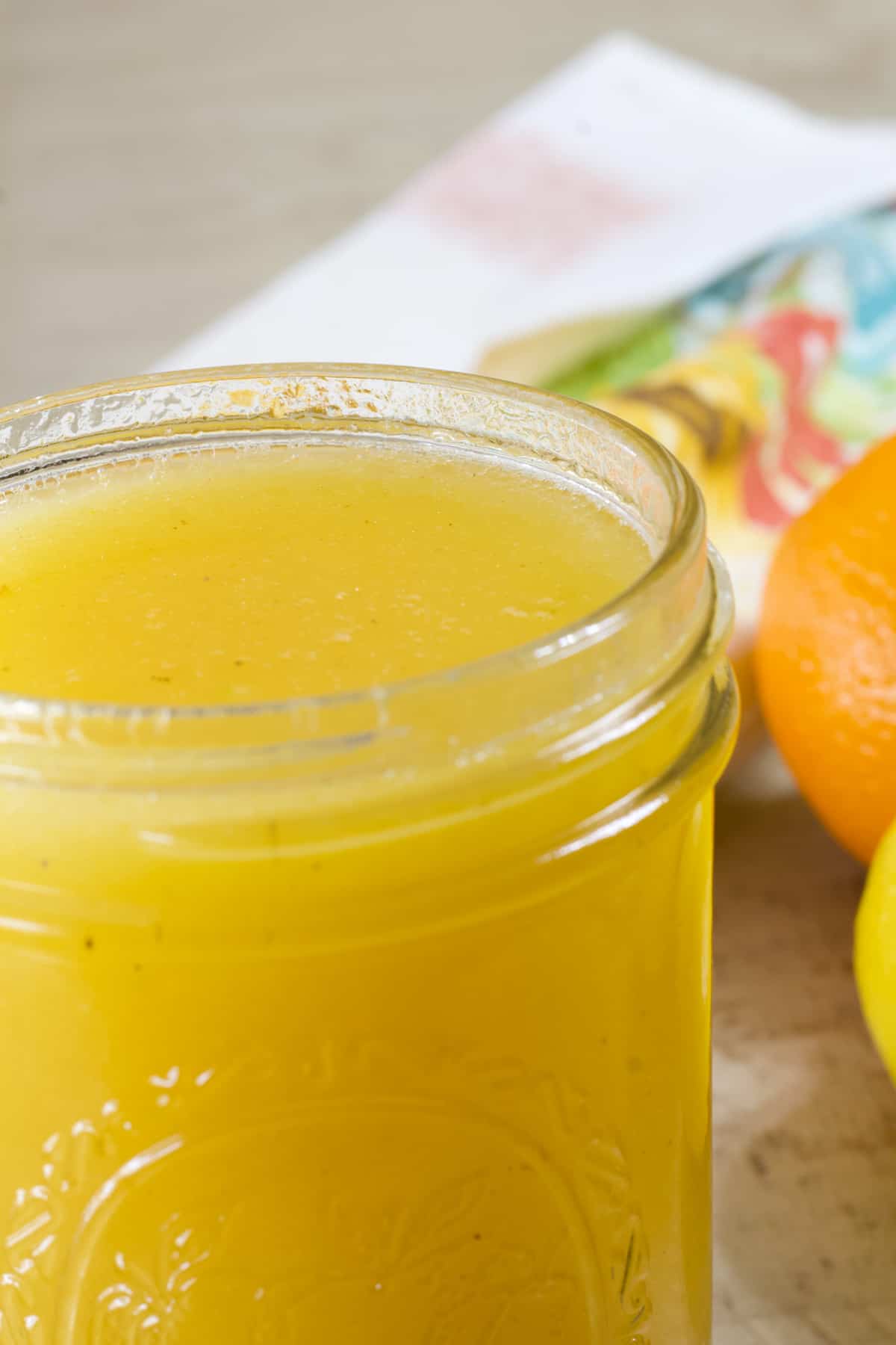 A very close up view of the top of a jar of citrus salad dressing.