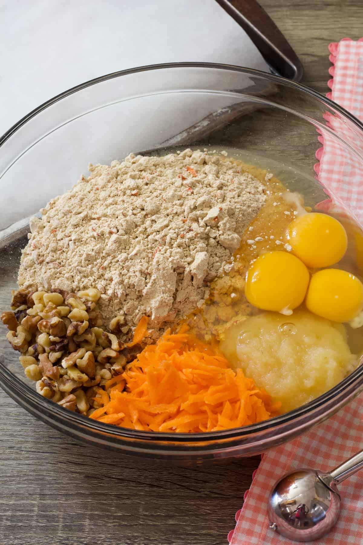 cake mix, eggs, carrots, applesauce and nuts in a bowl.