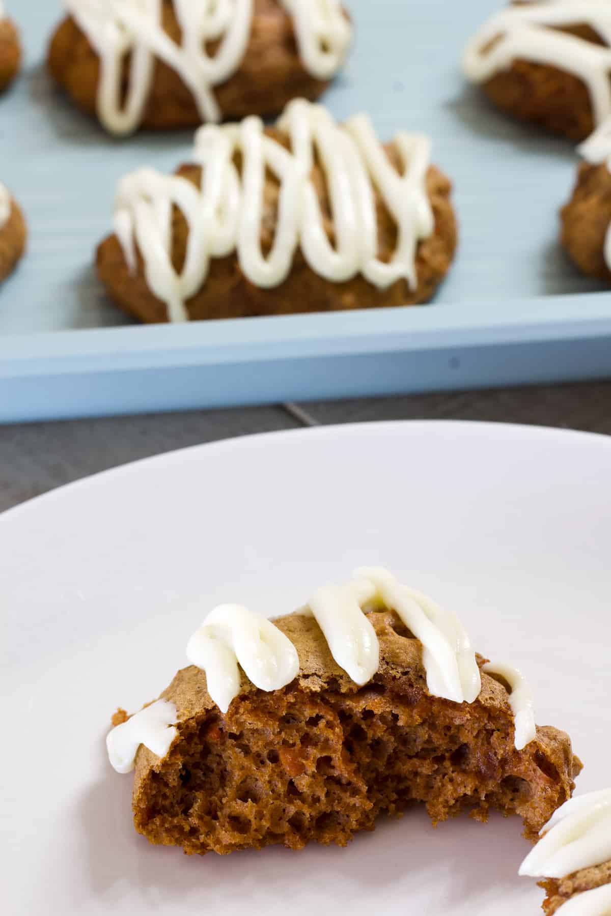 A close up view of a carrot cake cookie on a white plate.