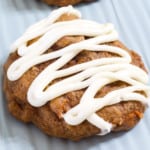 A close up view of a carrot cake cookie on a light blue sheet pan.