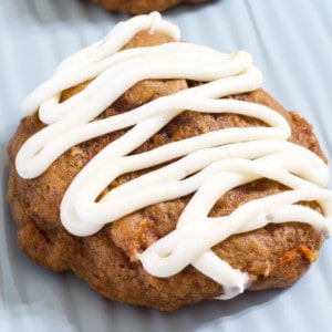 A close up view of a carrot cake cookie on a light blue sheet pan.