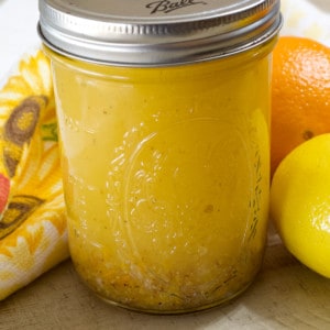 A close up view of a mason jar filled with citrus vinaigrette.