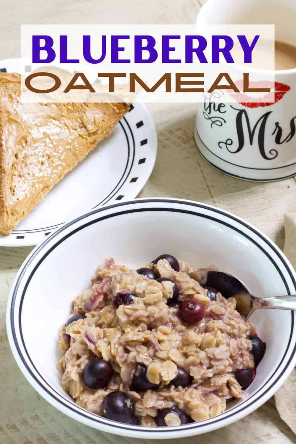 Overhead shot of a bowl of blueberry oatmeal, cup of coffee and toast with peanut butter. 