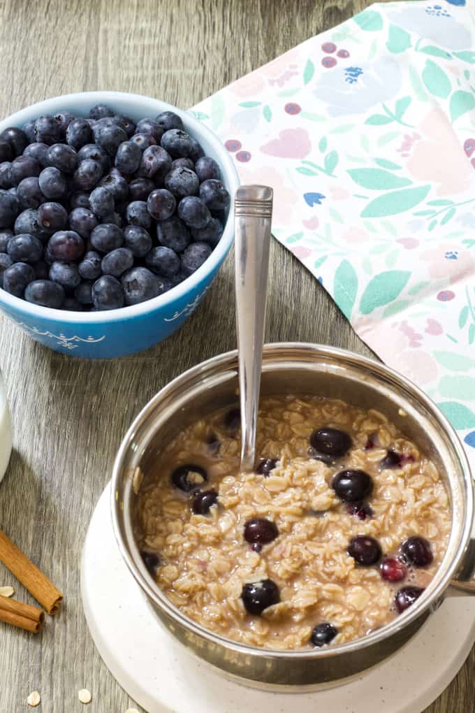 A pan of blueberry oatmeal and a bowl of fresh blueberries.