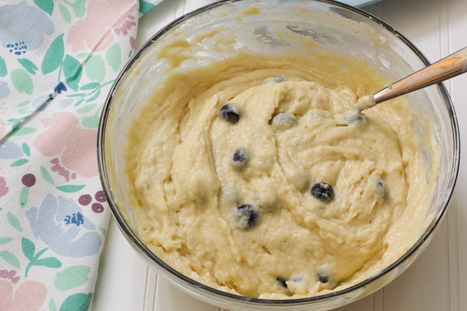 The mixed up muffin batter in a large glass bowl.