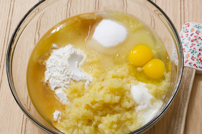 A glass bowl with the ingredients for the cake in it, not mixed up.